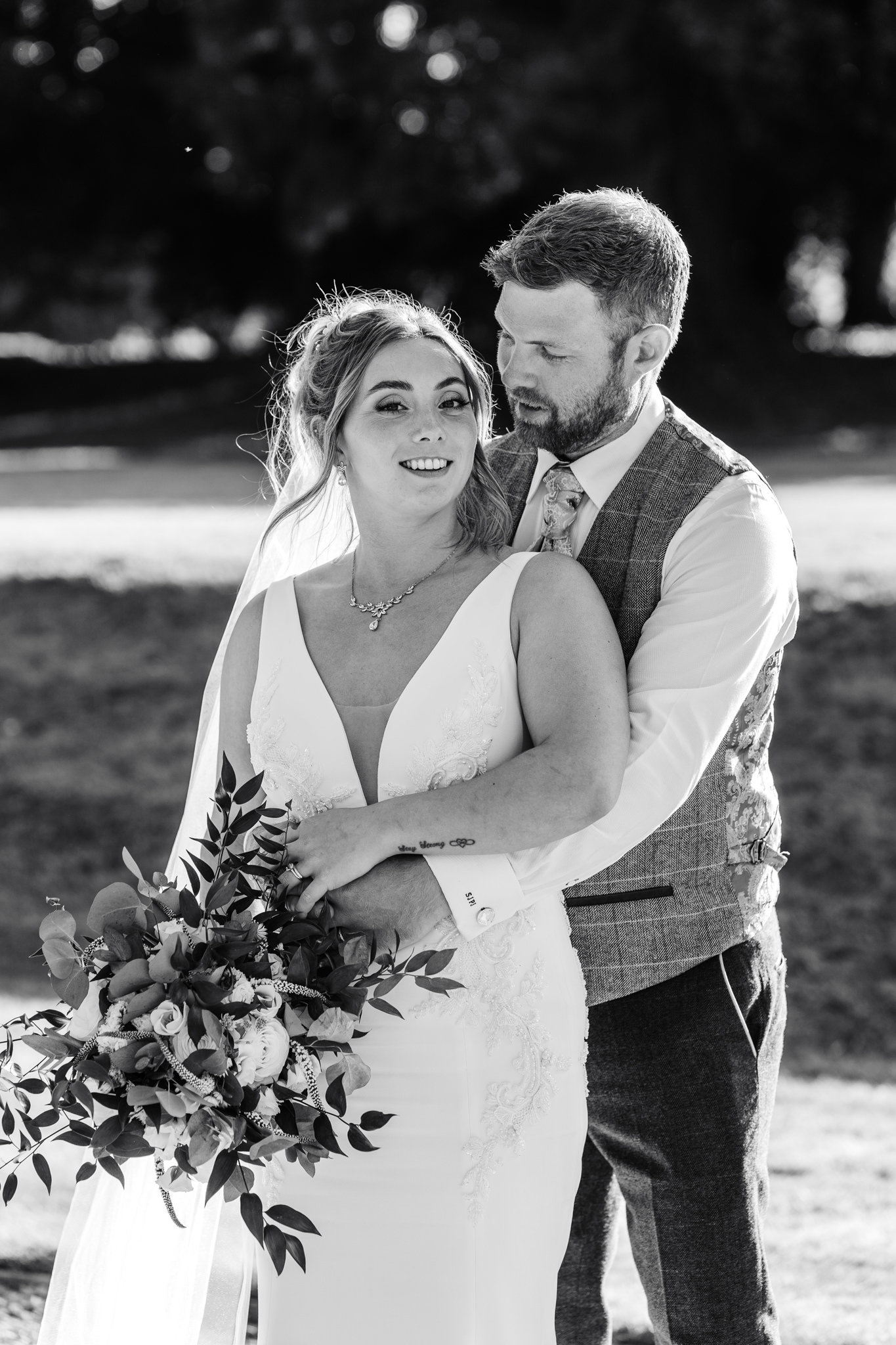 bride and groom embracing during their wedding at oakley hall