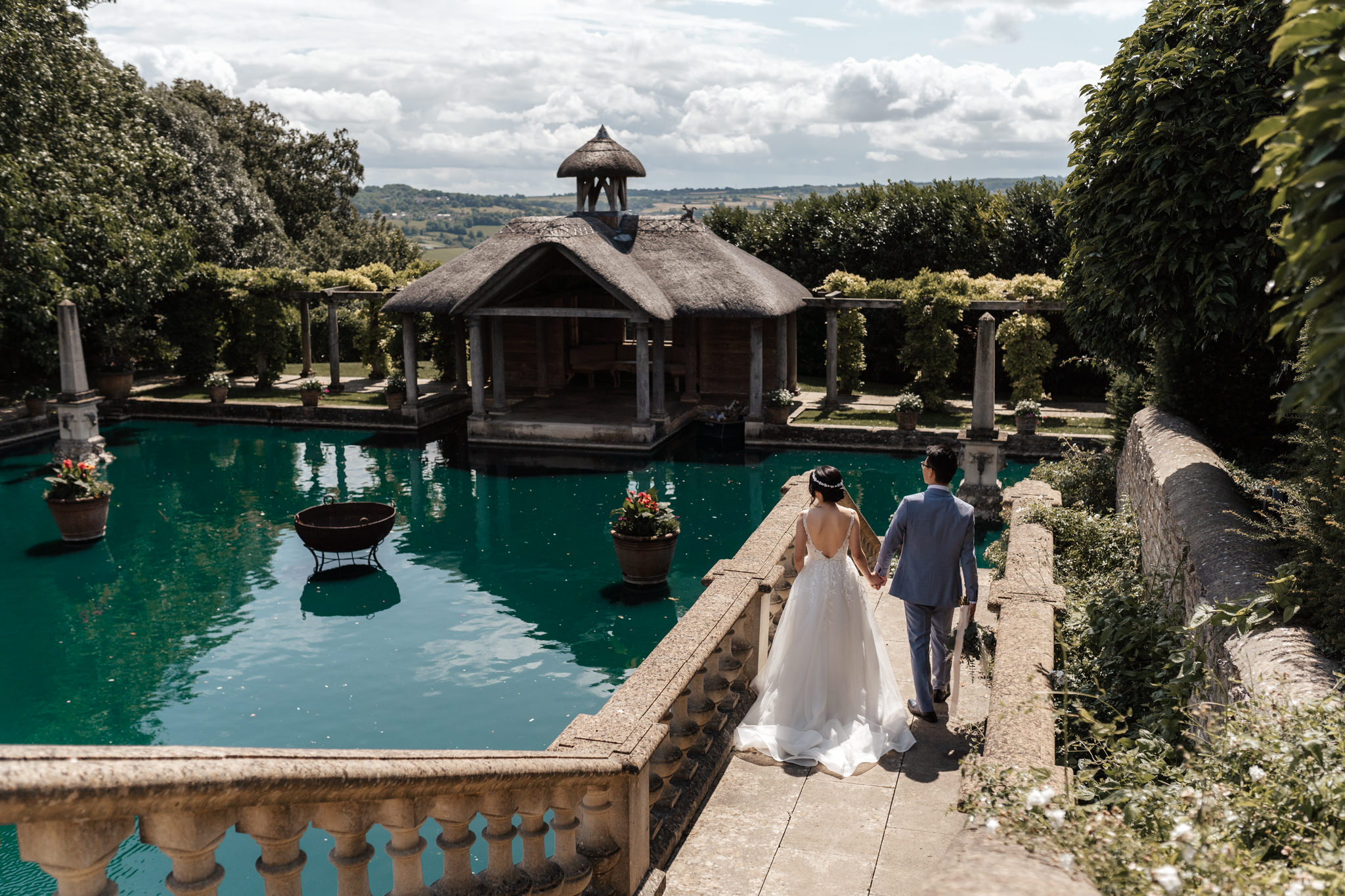 bride and groom walking down the steps and looking out to the beautiful water at euridge manor