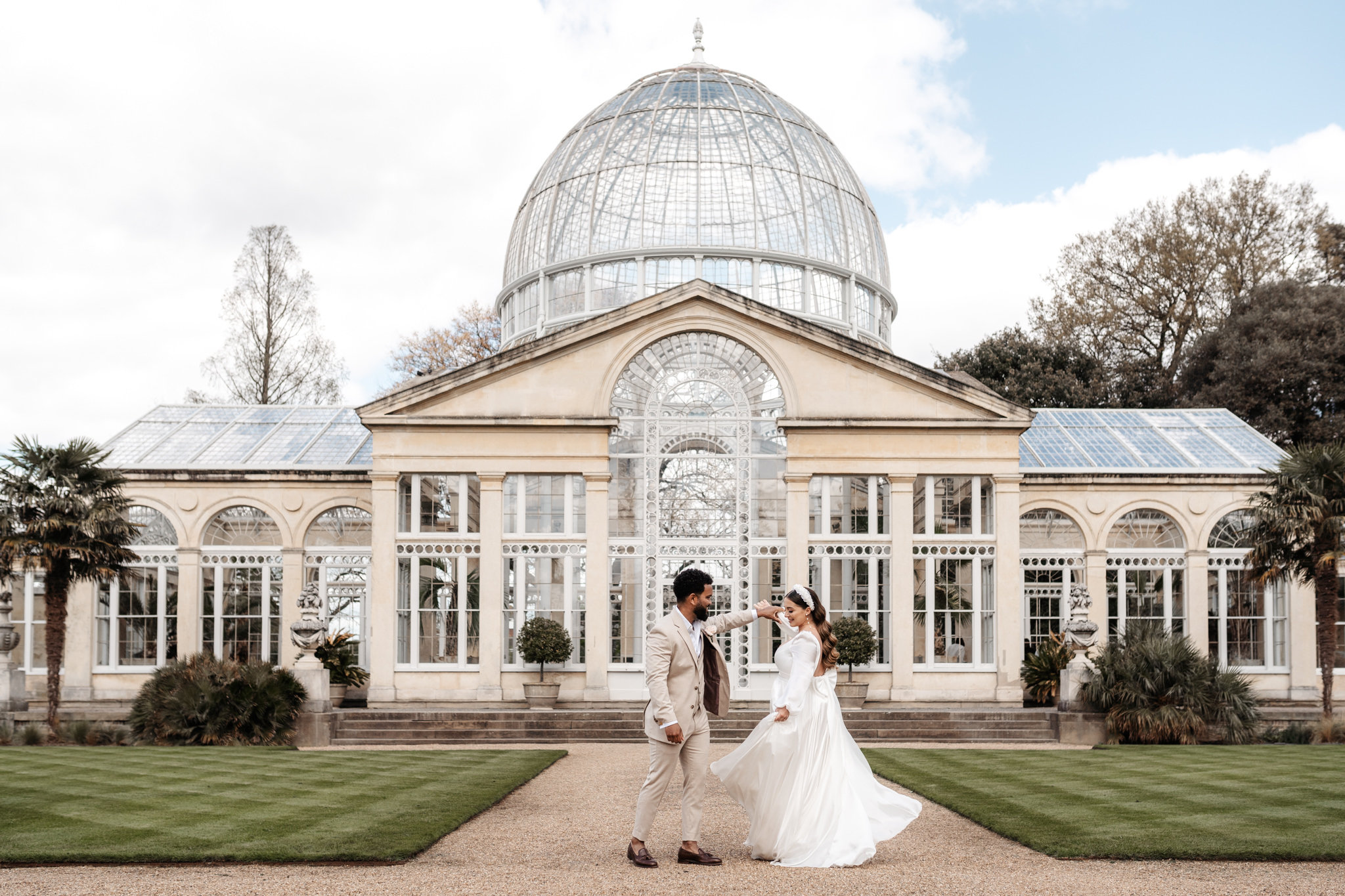 bride and groom with a beautiful view of syon park in the background