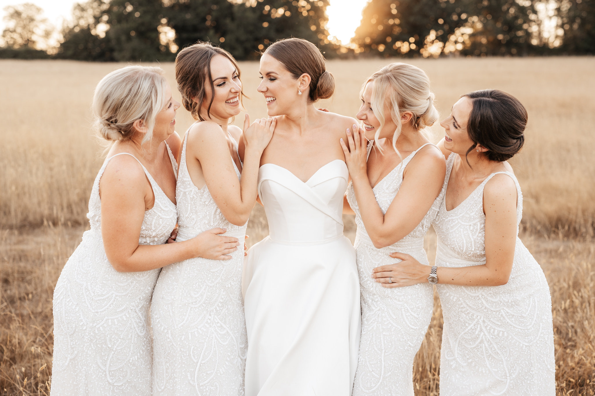bride with her bridesmaids in white dresses during a silchester farm wedding