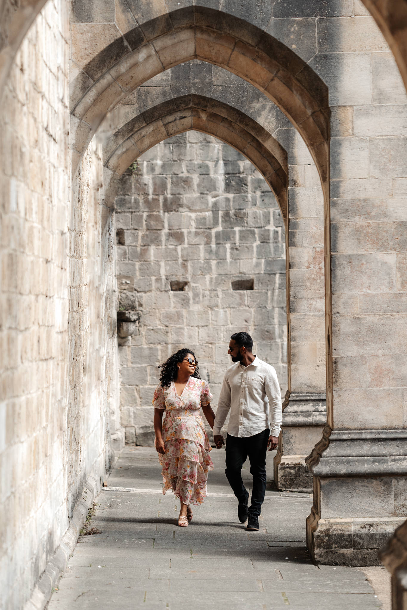 engagement photography session of a couple underneath beautiful archways at their winchester wedding venue