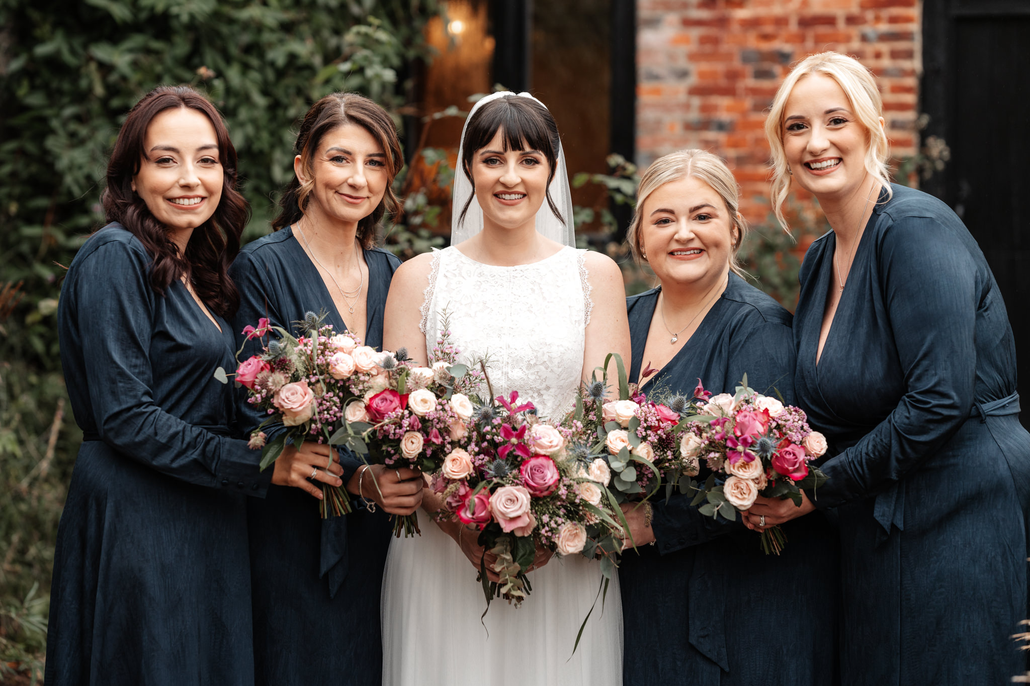 clock barn wedding with group photo of bridesmaids and bride