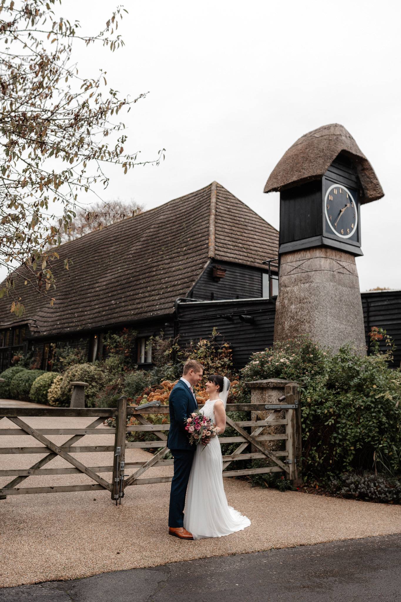 bride and groom stood at their clock barn wedding in hampshire
